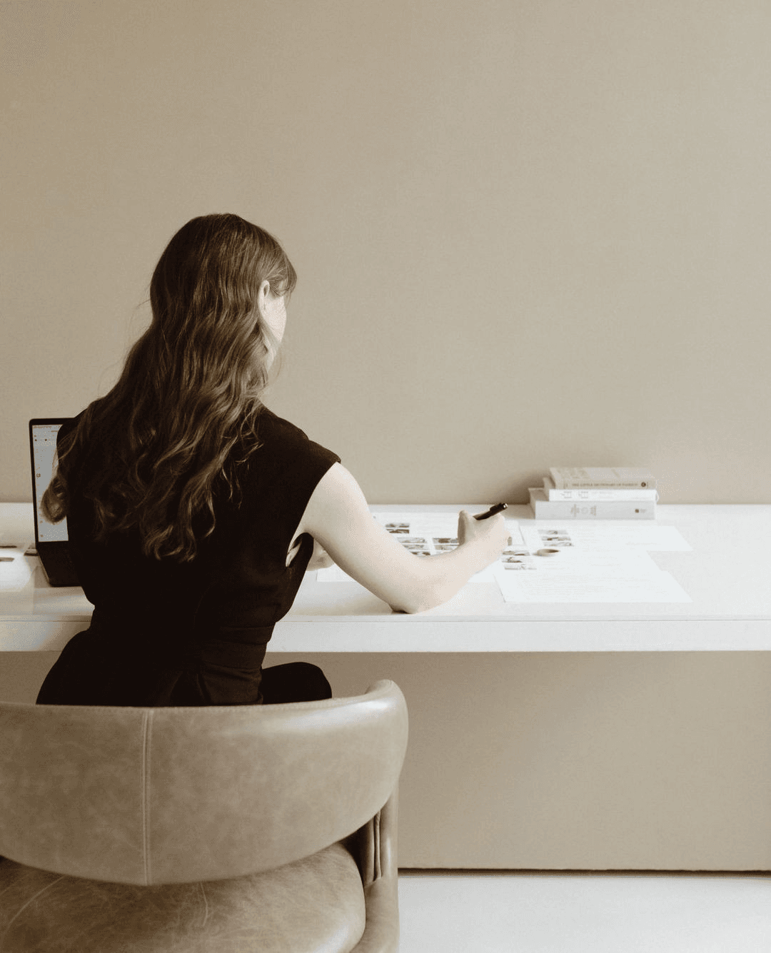 A product designer planning mobile app workflows at a desk